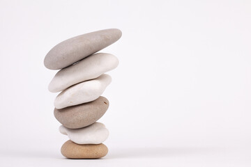 Reverse stack of zen pebbles isolated on white