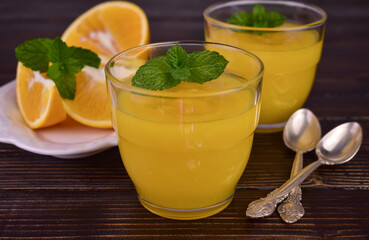 Orange cream (English citrus cream) in glasses on a dark wooden background.