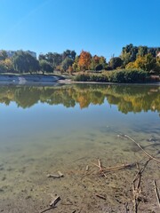 Lake on a clear autumn day. Reflection in the water and stunning autumn colors.