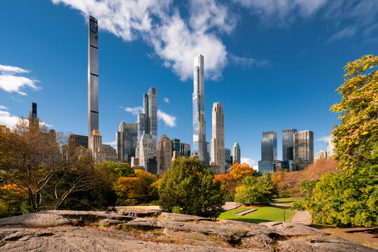 Central Park in Fall with view of the skyscrapers of Billionaires' Row in morning light. Midtown Manhattan, New York City