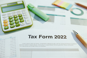 tax form 2022 and calculator at table