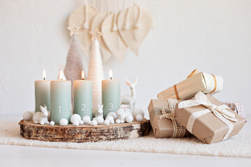Handmade modern advent wreath with four candles lit every sunday before christmas. Traditional diy xristmas decoration