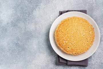 Thin pancakes on a plate, top view, concrete background. The concept of a delicious breakfast or Maslenitsa copy space