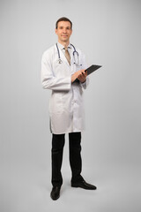 Full length portrait of smiling male doctor. Medical services.