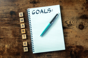 Smarter goals concept, a notepad with the handwritten word, ready for writing a list or a plan, top...