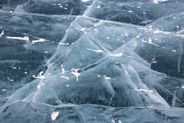 Texture of clean transparent ice on Baikal with a beautiful pattern and cracks