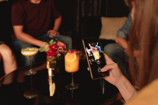 Woman Hand Taking A Photo Of A Cocktail With Her Mobile Phone