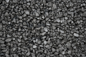 The texture of pieces of coal lying on top of each other.