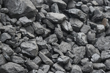 The texture of pieces of coal lying on top of each other.