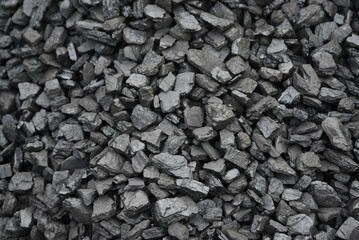 The texture of pieces of coal lying on top of each other.