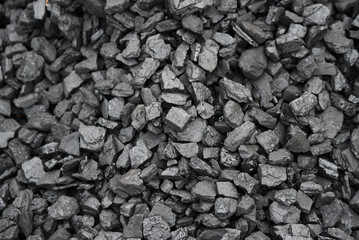 The texture of pieces of coal lying on top of each other.