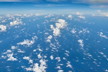 Fototapeta na wymiar Flying above ocean and clouds