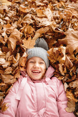 a child rejoices in the fallen leaves