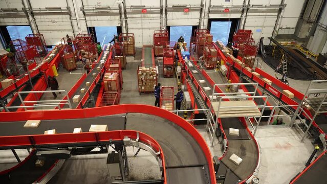 Kyiv, Ukraine - February 2021.
Automated, sorting line of conveyor sorting of parcels. A company that provides express delivery of goods and parcels for individuals and businesses. Logistics center.