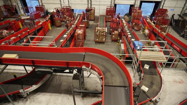 Kyiv, Ukraine - February 2021.
Automated, sorting line of conveyor sorting of parcels. A company that provides express delivery of goods and parcels for individuals and businesses. Logistics center.