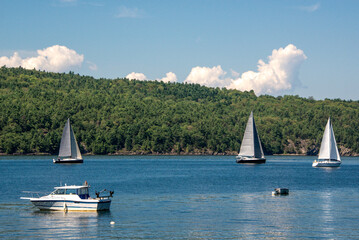 Boats at mooring and sailboats sailing in Willsboro Lake Champlain Bay