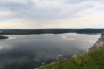 A calm smooth water view. The landscape of Bakota, Dniester river, Ukraine. The banks of a large river.