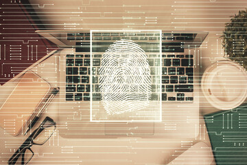 Finger print over computer on the desktop background. Top view. Double exposure. Concept of...