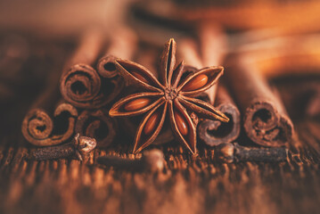 Close-up Christmas spices, star anise, cinnamon sticks, cloves. Side view, selective focus. Toned...