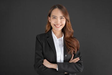 Business woman wearing a black suit Standing with arms crossed.