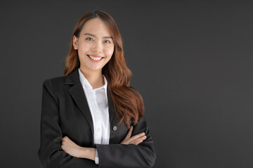 Business woman wearing a black suit Standing with arms crossed.