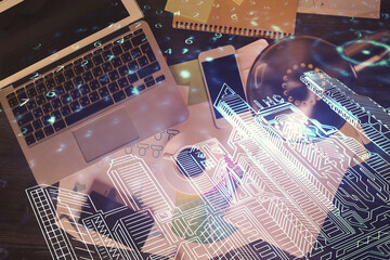 City drawing over computer on the desktop background. Top view. Double exposure. Smart home concept.