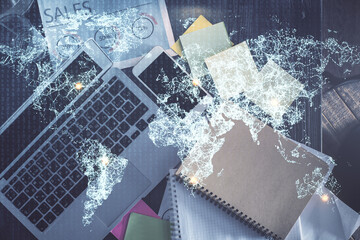 Social network hologram drawings over computer on the desktop background. Top view. Double exposure.