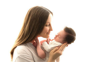 Close-up portrait of a young mother and newborn born. Mother holds in her arms, gently hugs, kisses a beautiful newborn daughter. The concept of love, happy motherhood. Photo on a white background.