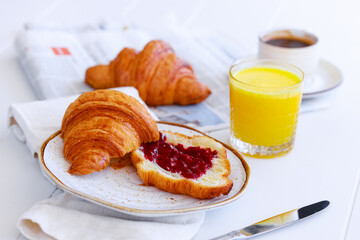 Classic french breakfast with croissant with jam, coffee and orange juice