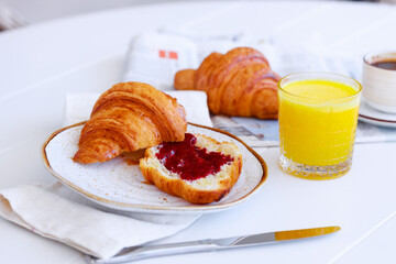 Classic french breakfast with croissant with jam, coffee and orange juice