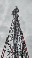 Technology background of telecommunications tower during cloudy day