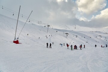 Fototapeta na wymiar Skiing slopes, with many people