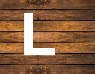 L capital letter of alphabet in white hole on wood background