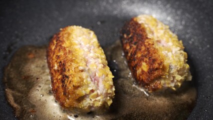 Fry fillet cutlet in pan in home kitchen. Minced meat and spices, raw breaded burger. Food cooking, much fat, delicious frying