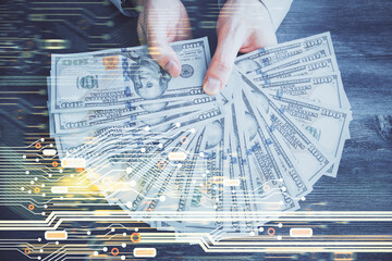Multi exposure of technology drawing hologram and us dollars bills and man hands. Data concept
