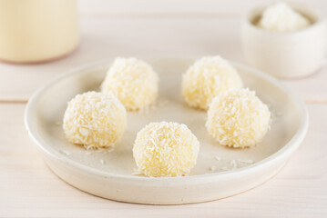 Coconut bejinho brigadeiro, a traditional Brazilian truffle on a table.