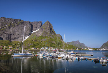 Fototapeta na wymiar Boats in Reine harbour, and mountains, Moskenesoya, Lofoten Islands, Nordland, Norway