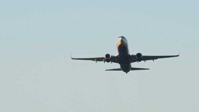 Low angle view of passenger airplane takeoff from airport in the morning. Airplane takes off over head. Airplane taking off from the airport