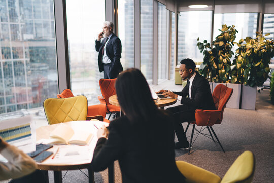 Group of diverse businesspeople working in office cafeteria