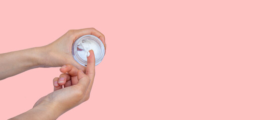 Hand with moisturizer cream. Skin care concept photo. Web banner. Large copy space area.