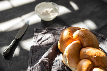 Challah Shabbat braided bread with silver knife and cottage cheese. Traditional Meal for Jewish cuisine Friday or Saturday dinner. 