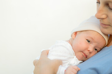 baby smiling and looking up to camera outdoors in sunlight