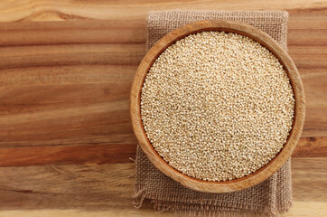 Top view image of quinoa in wooden plate on table