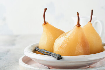 Pears. Poached pears in syrup. Traditional dessert sliced server in a white plate with leaves and...