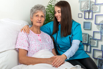 Nurse helping senior woman in hospital
