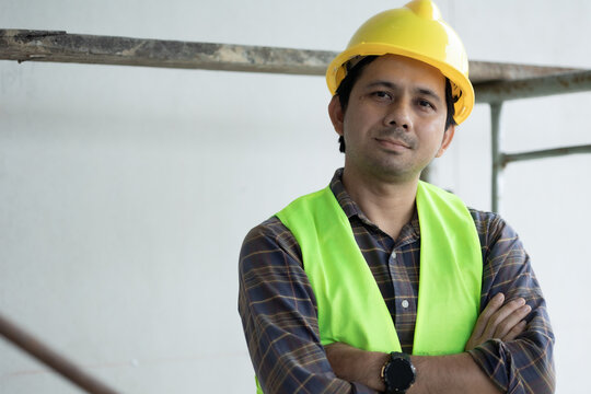 portrait of asian construction worker looking at camera - Powered by Adobe