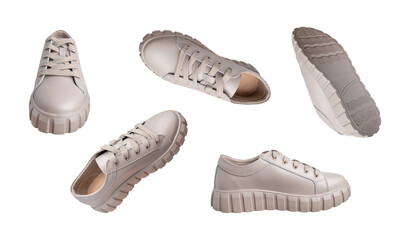 Beige gray leather female sneakers with lace isolated on white background. Flying fashion casual sneakers, sports unisex clothing shoes. Minimal mockup with footwear. Different viewing angle