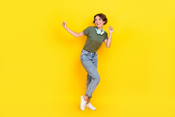 Fototapeta na wymiar Full length photo of funky cheerful lady wear stylish clothes good mood look empty space isolated on yellow color background
