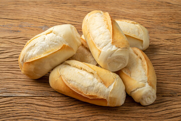 French bread, salt bread or pistolet over wooden table