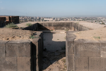 Entrance to Susi temple with cuneiform inscriptions on the walls on sunny summer morning. Erebuni fortress, Yerevan, Armenia.